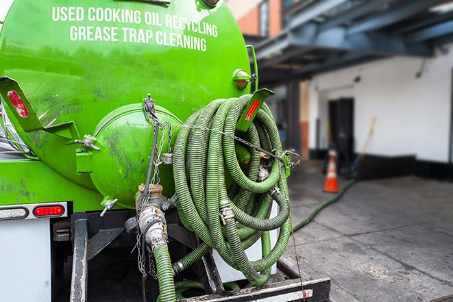 a grease trap being pumped by a sanitation technician in Wynantskill, NY